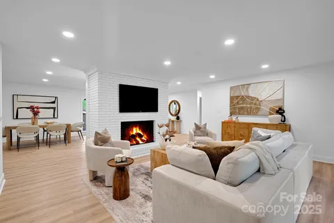 a living room with furniture and large windows