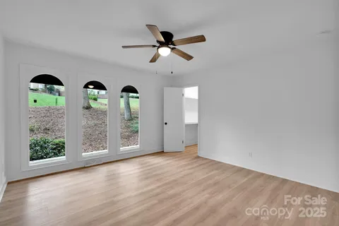 a bathroom with a granite countertop sink a mirror a vanity and shower