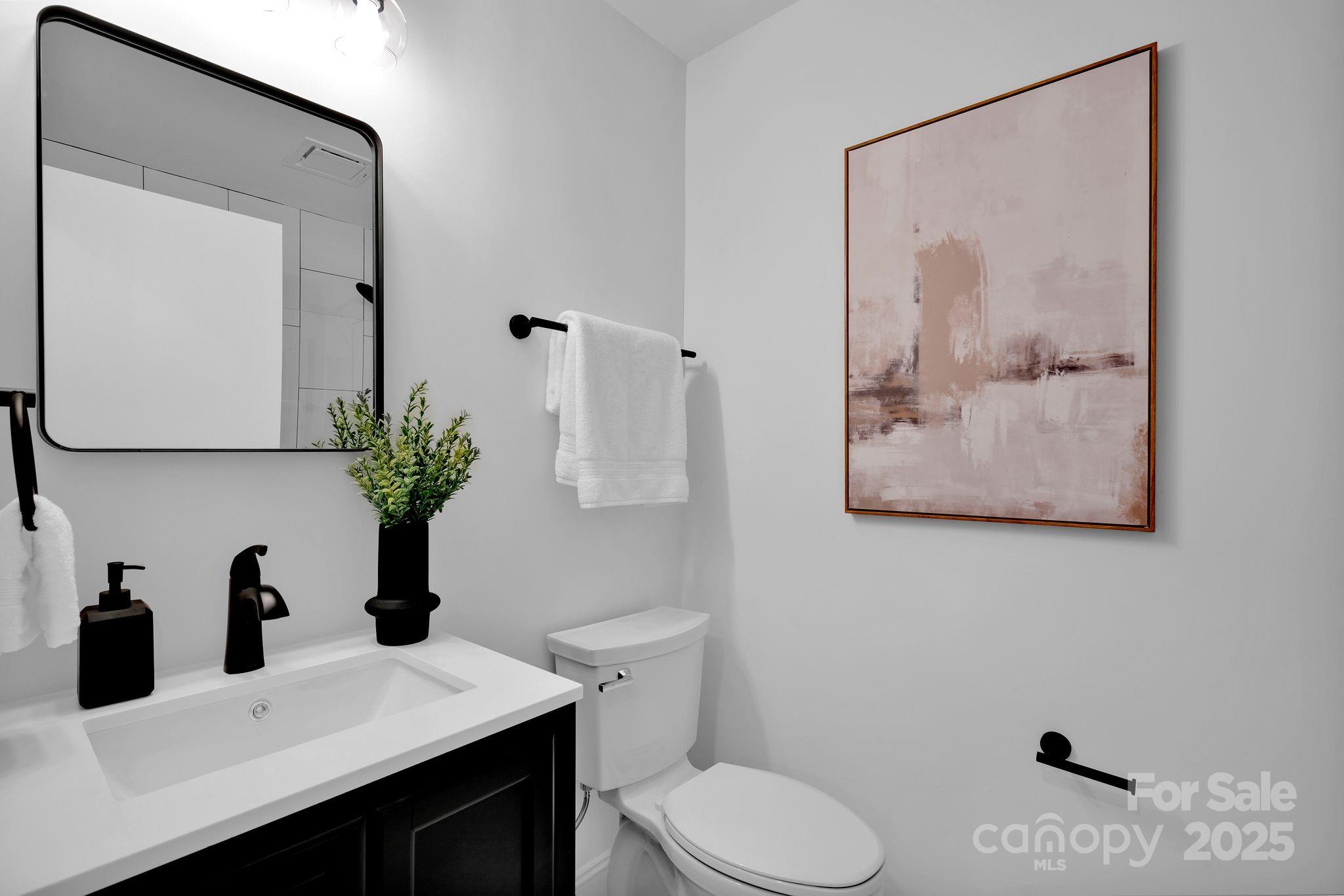 3200 Highview Road Charlotte, NC 28210 - Photo 30 of 48 a bathroom with a toilet sink and mirror