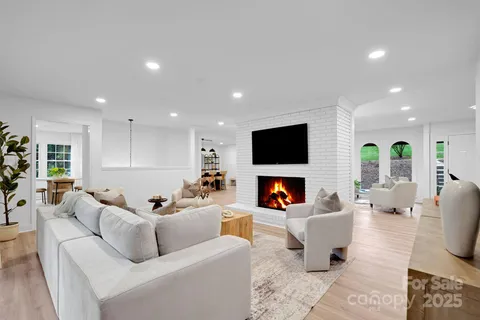 a living room with fireplace furniture and a flat screen tv