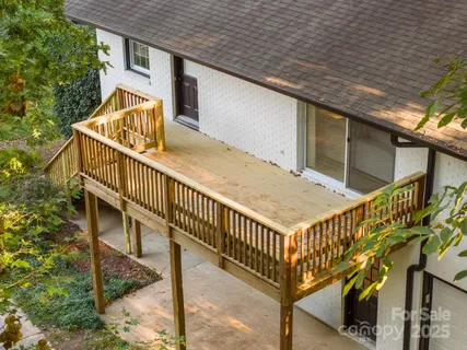 a view of a house with a yard and potted plants