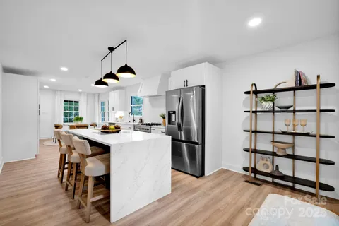 a kitchen with stainless steel appliances a stove a refrigerator and a refrigerator