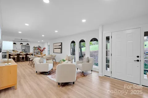 a living room with furniture fireplace and wooden floor