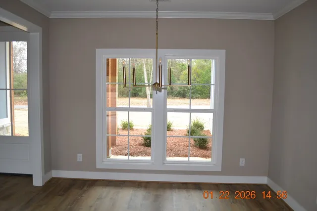 a kitchen with stainless steel appliances granite countertop a sink a stove and a wooden floors