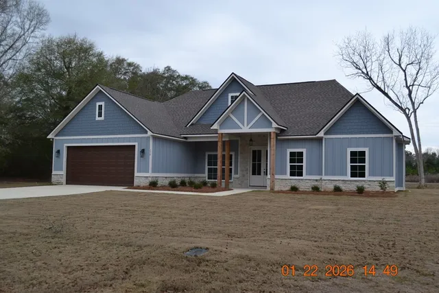 a front view of a house with yard