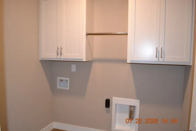 an empty room with a window and wooden floor
