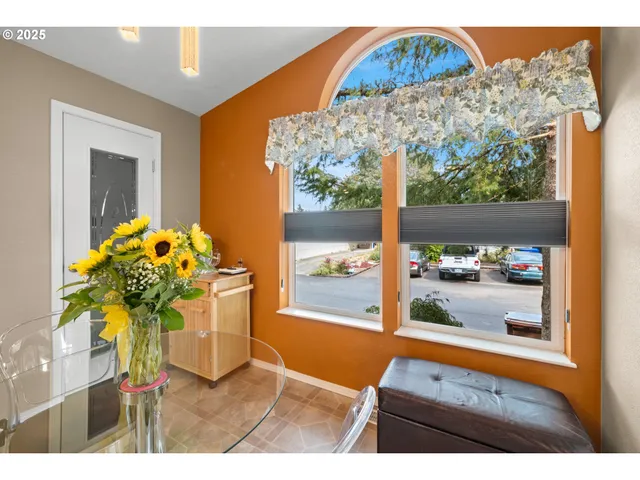 a vase of flowers sitting on a table with a glass door