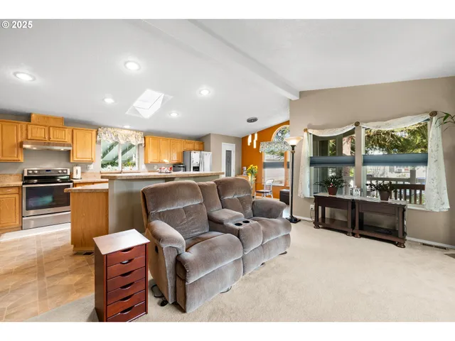 a living room with furniture and a kitchen view