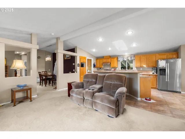 a living room with furniture and kitchen view