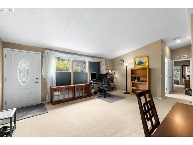 a view of a livingroom with furniture and a window