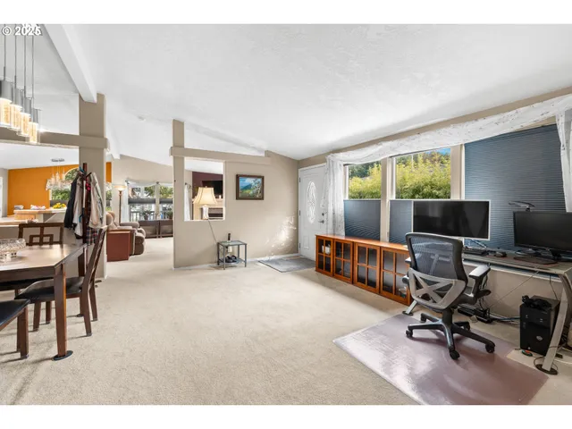 a view of a livingroom with workspace and a window