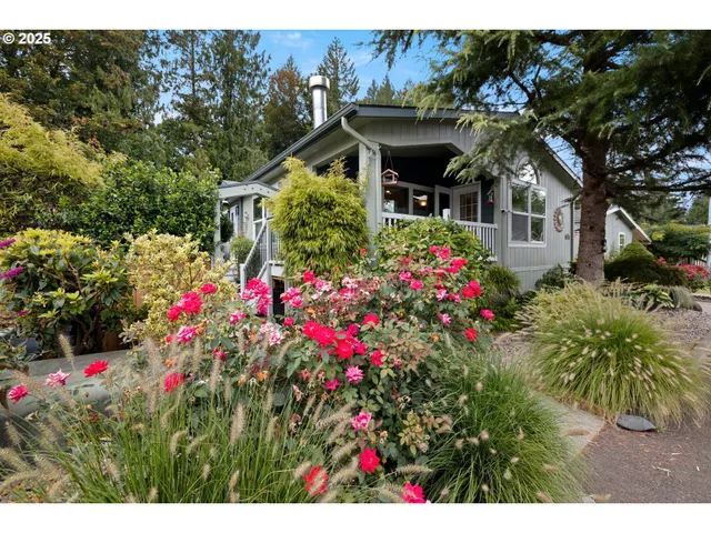 a view of a house with a lot of flower plants