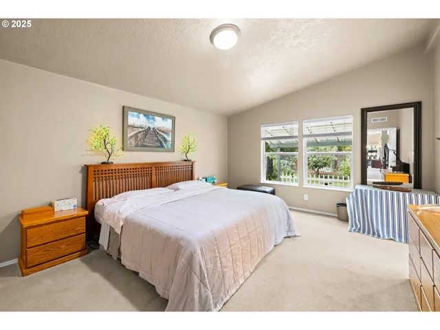 a bedroom with a bed and a large window