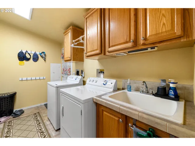 a utility room with a sink a washer and dryer