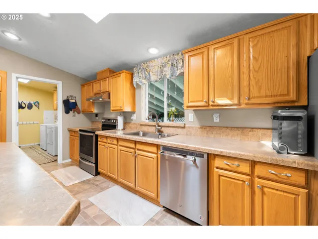 a kitchen with granite countertop cabinets and window
