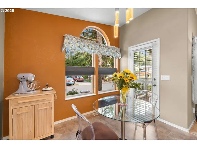 a view of a dining room with a table and chairs