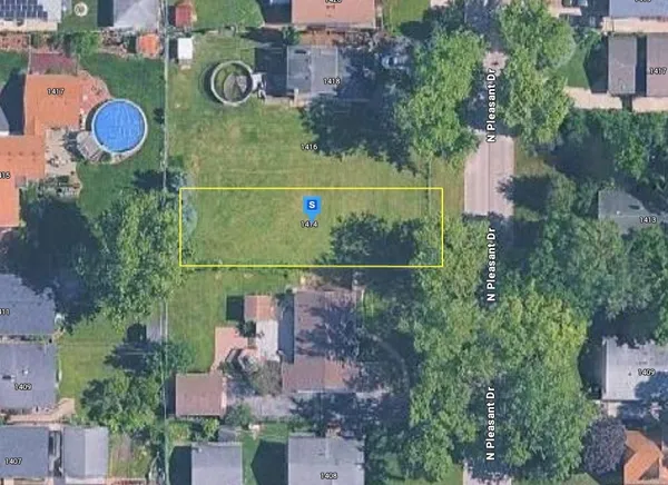 an aerial view of residential house with outdoor space and parking