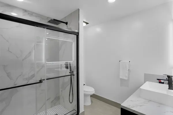 a bedroom with a large bed and a flat tv screen on dresser