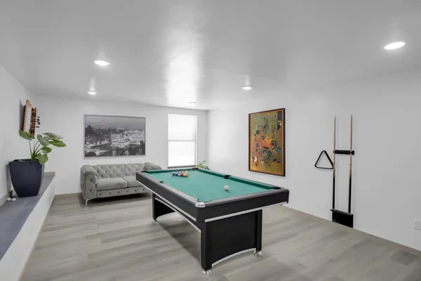 a dining hall with couches a coffee table and chairs with outer view