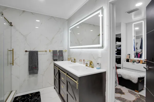 a spacious bedroom with a bed and a flat screen tv