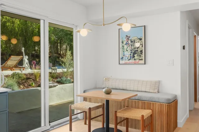 a kitchen with a sink and a stove with wooden floor