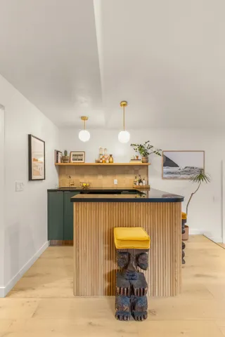 a view of a dining room with furniture and a window