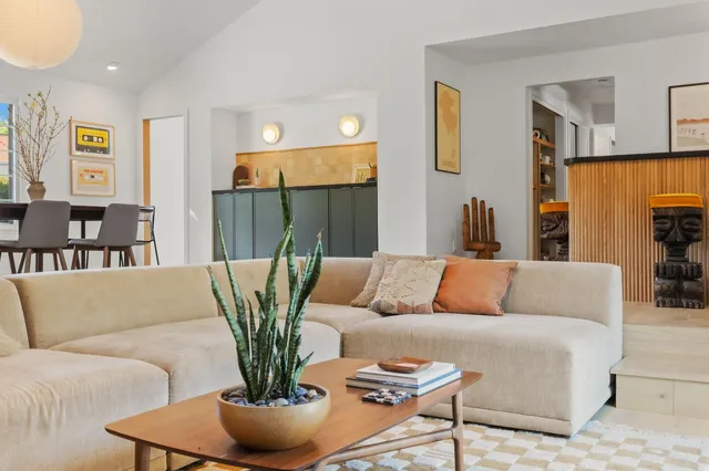 a living room with furniture and a potted plant