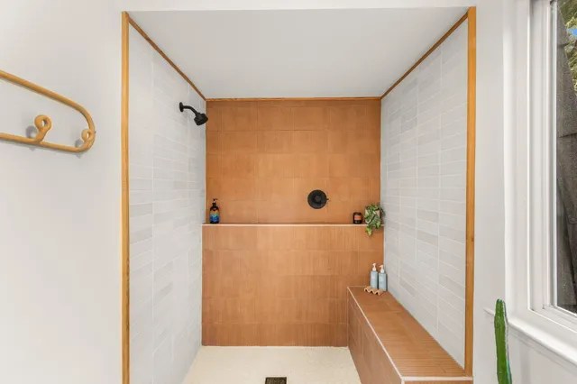 a balcony with wooden floor table and chairs