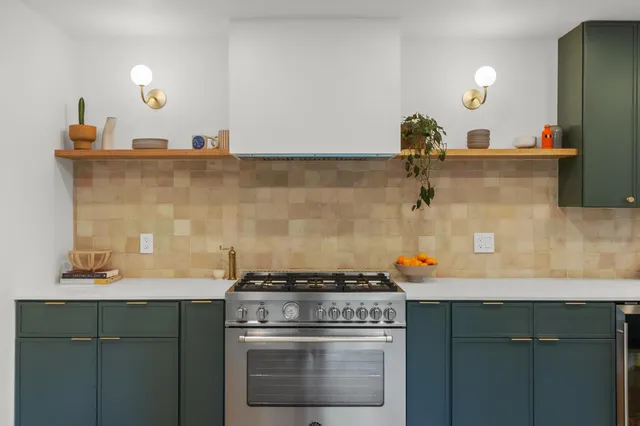 a large kitchen with a large counter top stainless steel appliances a sink and counter space