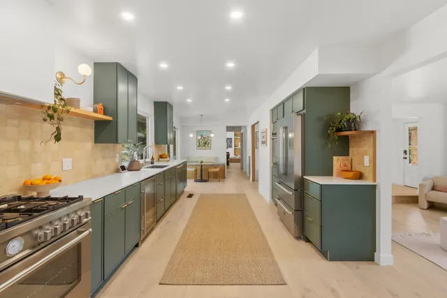 a living room with furniture a large window and storage