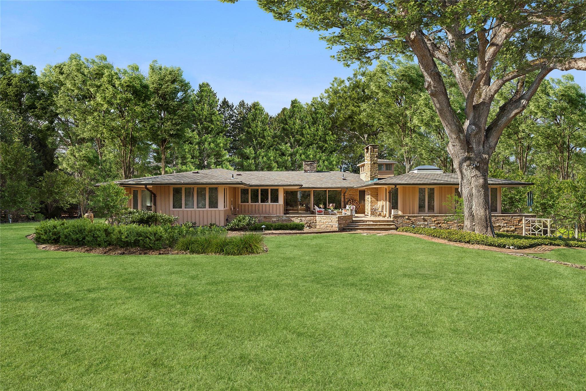 a front view of a house with a garden