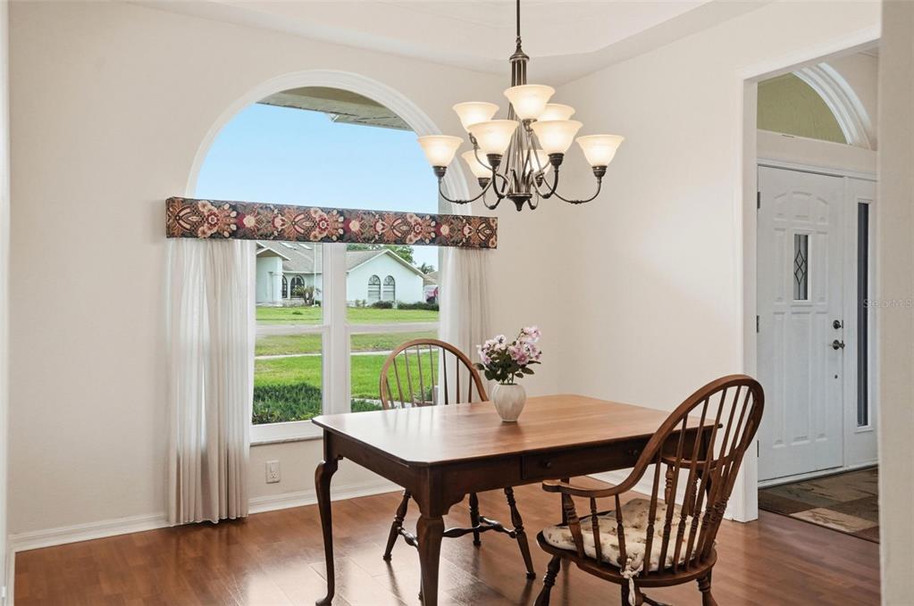 14228 Presteign Lane Spring Hill, FL 34609 - Photo 36 of 89 a view of a dining room with furniture wooden floor and chandelier
