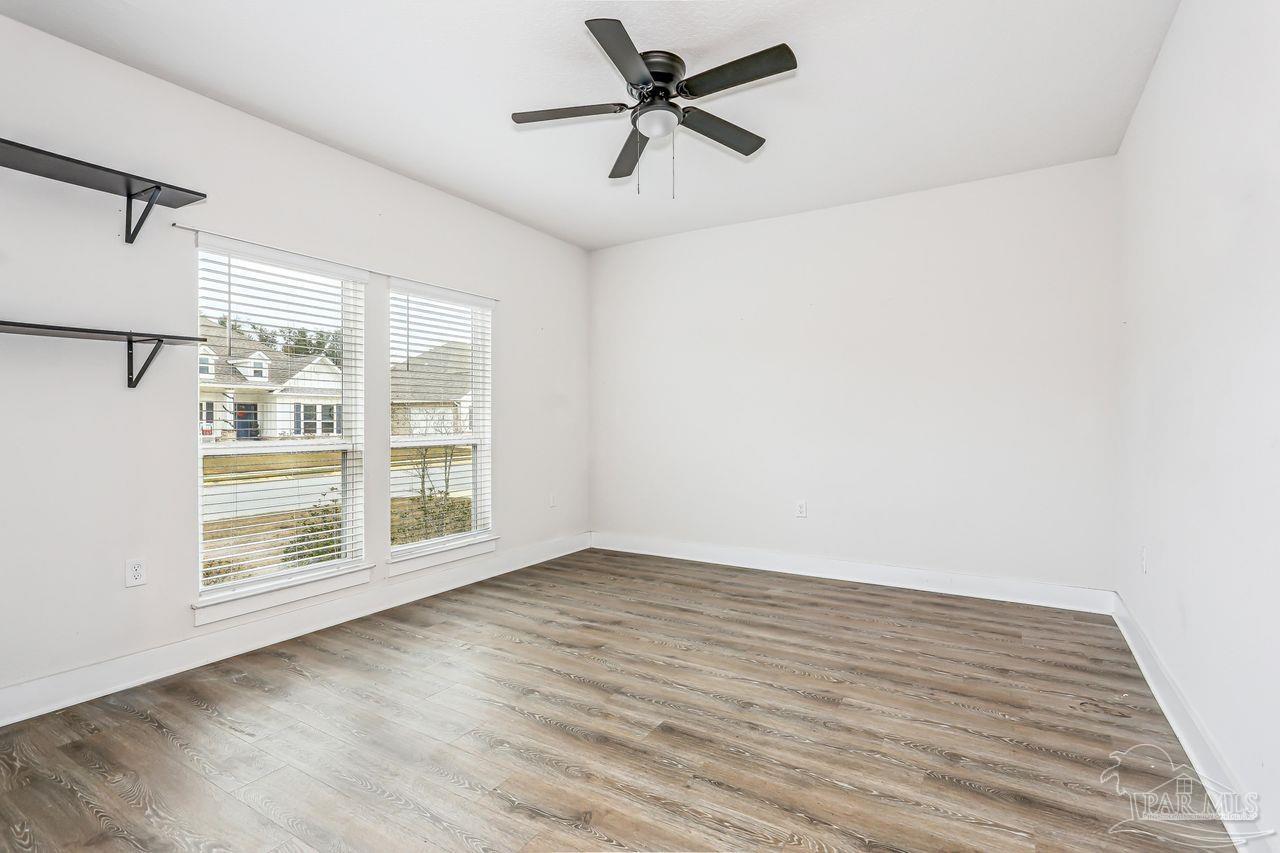 5665 Blake Lane Pace, FL 32571 - Photo 12 of 44 wooden floor in an empty room with a window