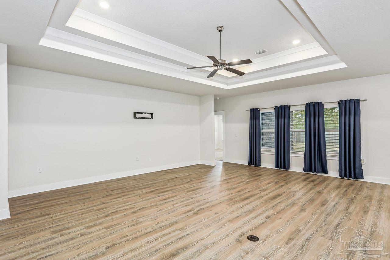 5665 Blake Lane Pace, FL 32571 - Photo 14 of 44 a view of a livingroom with a ceiling fan window and wooden floor