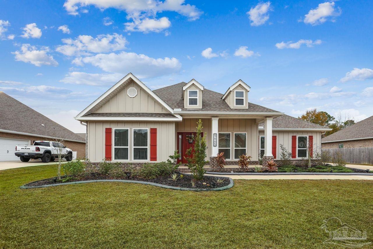5665 Blake Lane Pace, FL 32571 - Photo 2 of 44 a front view of a house with swimming pool having outdoor seating
