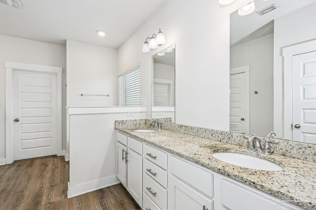 5665 Blake Lane Pace, FL 32571 - Photo 24 of 44 a bathroom with a granite countertop double vanity sink and mirror