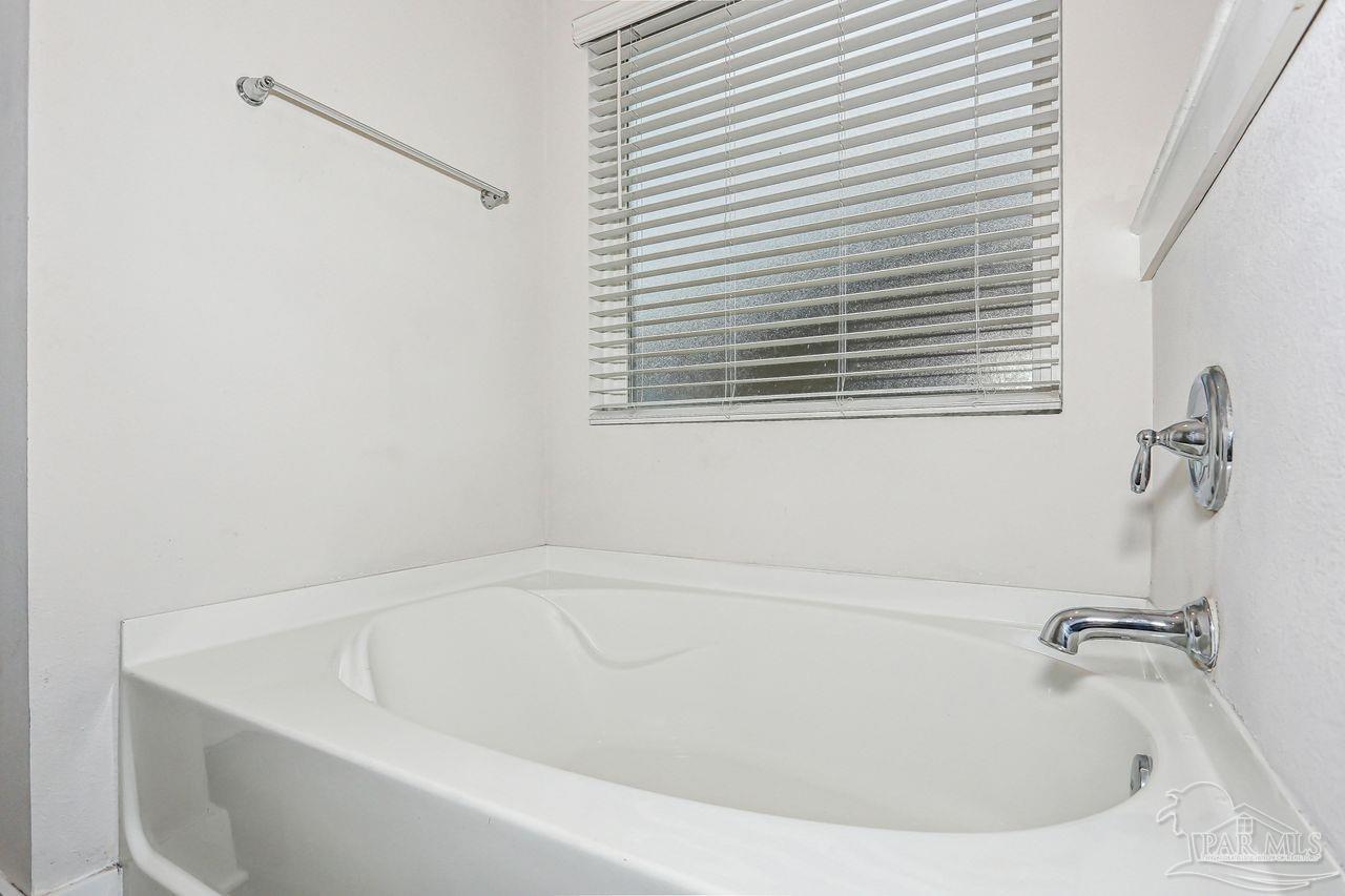 5665 Blake Lane Pace, FL 32571 - Photo 25 of 44 a white bath tub sitting next to a window