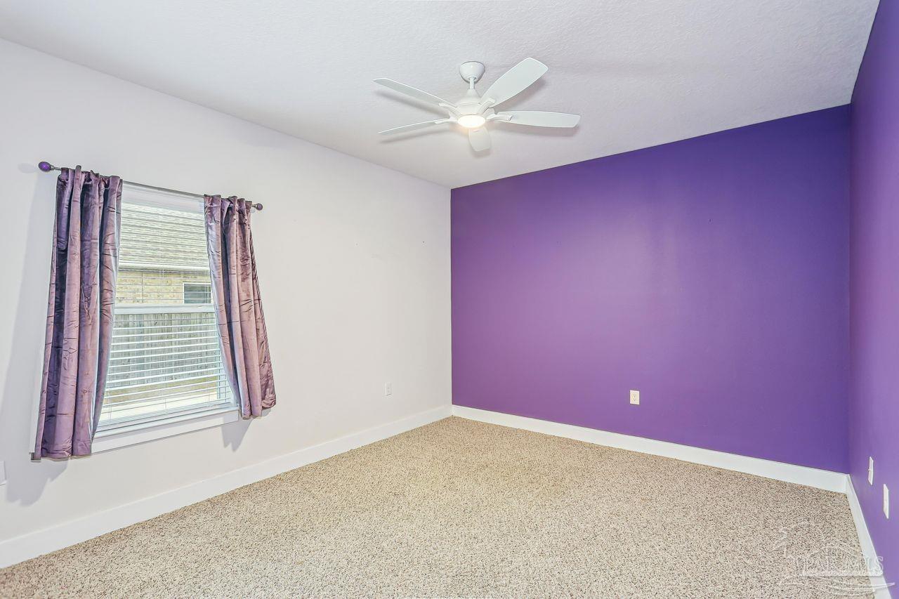 5665 Blake Lane Pace, FL 32571 - Photo 32 of 44 an empty room with windows and fan
