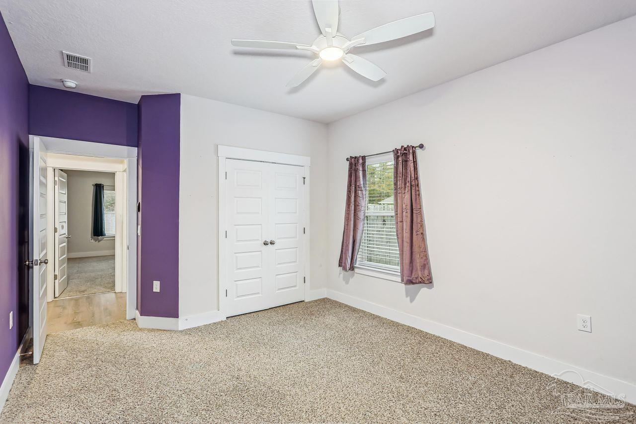 5665 Blake Lane Pace, FL 32571 - Photo 33 of 44 an empty room with windows and closet