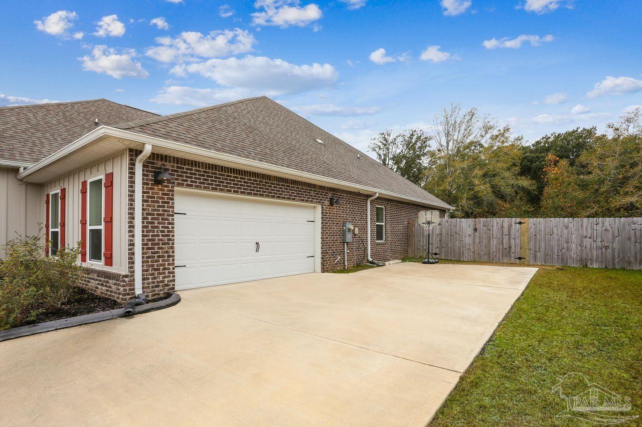 5665 Blake Lane Pace, FL 32571 - Photo 4 of 44 a front view of house with yard and trees in the background
