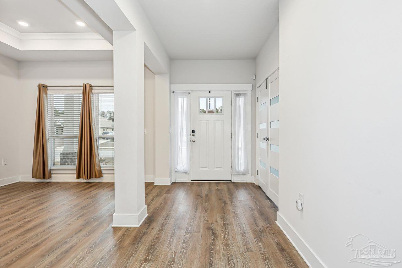 5665 Blake Lane Pace, FL 32571 - Photo 8 of 44 wooden floor in a hall with an entryway
