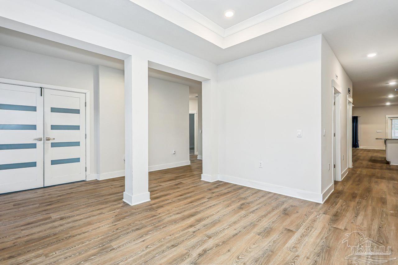 5665 Blake Lane Pace, FL 32571 - Photo 10 of 44 a view of empty room with wooden floor