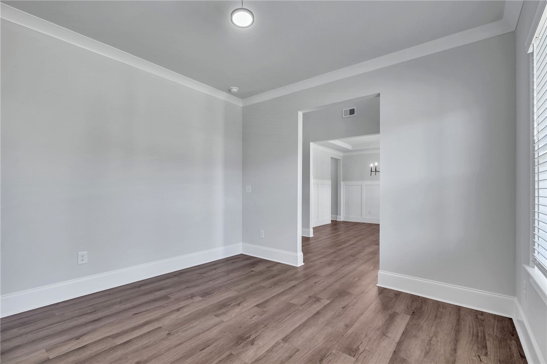 226 Holly Br Road Piedmont, SC 29673 - Photo 16 of 44 A well-proportioned room with robust plank flooring flows seamlessly into an adjacent space, perfect for flexible living.