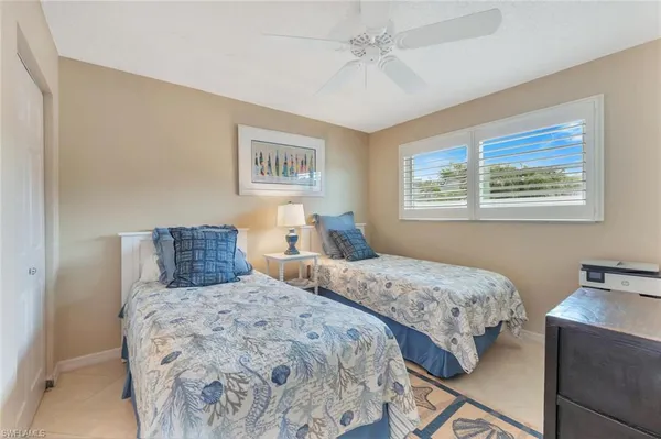 a bedroom with two beds and a window