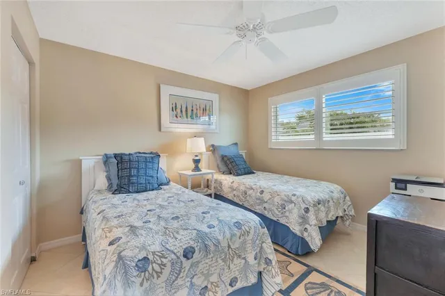 a bedroom with two beds and a window