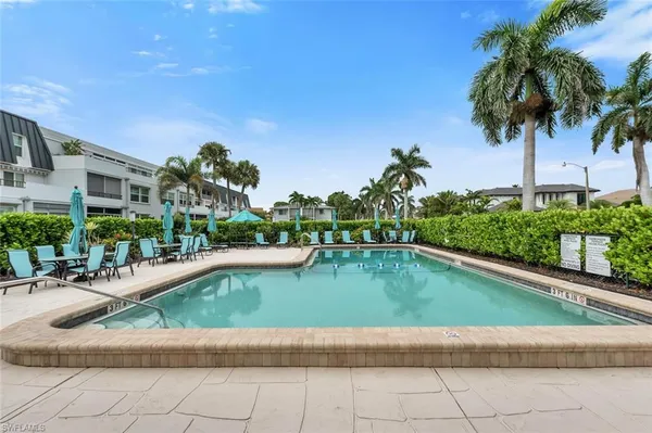a view of swimming pool with outdoor seating and plants