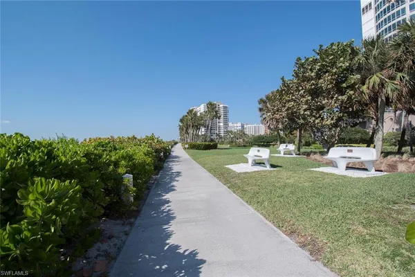 a view of a garden with a house