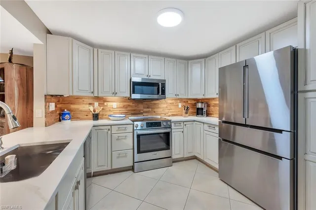 a kitchen with a refrigerator sink and microwave