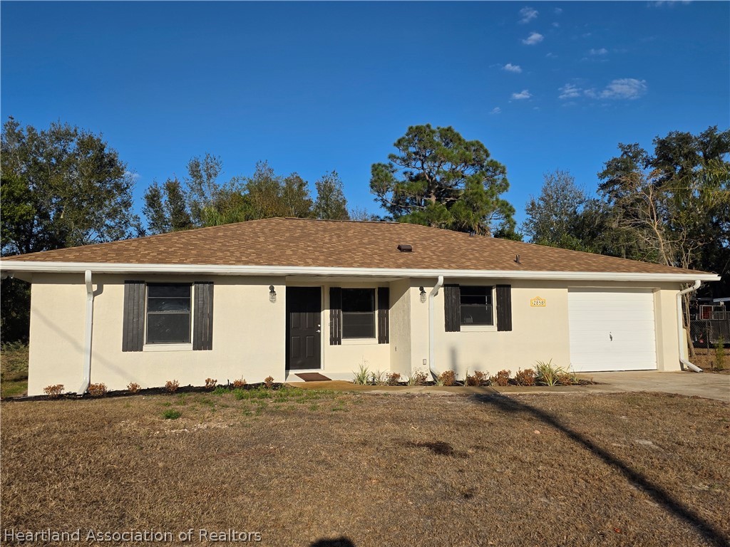 2858 North Lancaster Road Avon Park, FL 33825 - Photo 2 of 13 a view of a white house with a yard