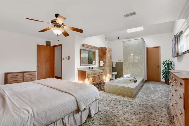 a bathroom with a sink toilet and mirror